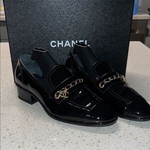 CHANEL Black Patent Leather Loafers with Gold Chain Detail